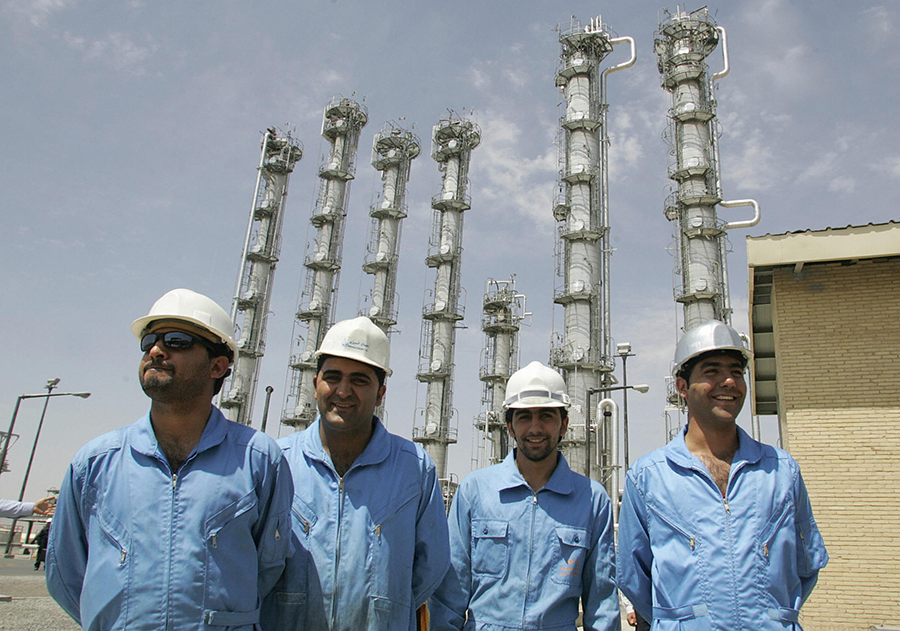 Iranian workers stand at the heavy water production plant in Arak when it opened in August 2006. The plant was to provide heavy water for the site's research reactor, which was later modified by the terms of 2015 Joint Comprehensive Plan of Action. (Photo: Atta Kenare/AFP/Getty Images)