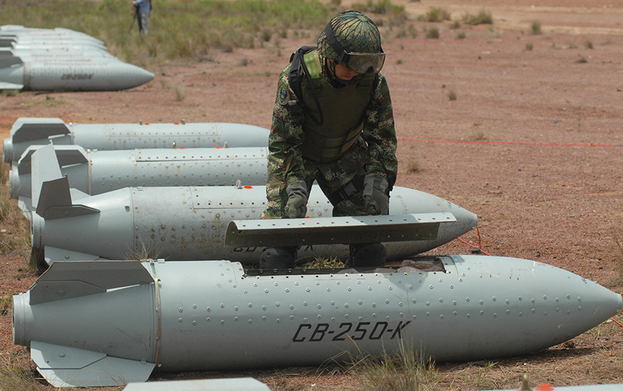 A Colombian Army bomb disposal expert works to dismantle a Chilean-made CB-250K cluster bomb in 2009. The effort completed Colombia's program to dispose of its final cluster munitions. (Photo: Luis Ramirez/AFP/Getty Images)