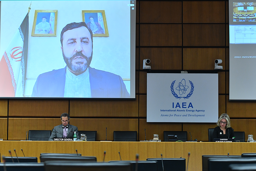 Iranian Amb. Kazzem Gharibabadi speaks to a virtual meeting of the IAEA Board of Governors on Nov. 20. Attending the meeting in a sparsely attended board room are IAEA Director-General Rafael Mariano Grossi (left) and Amb. Heidi Alberta Hulan of Canada, who began her one-year term as board chairperson in September. (Photo: Dean Calma/IAEA) 