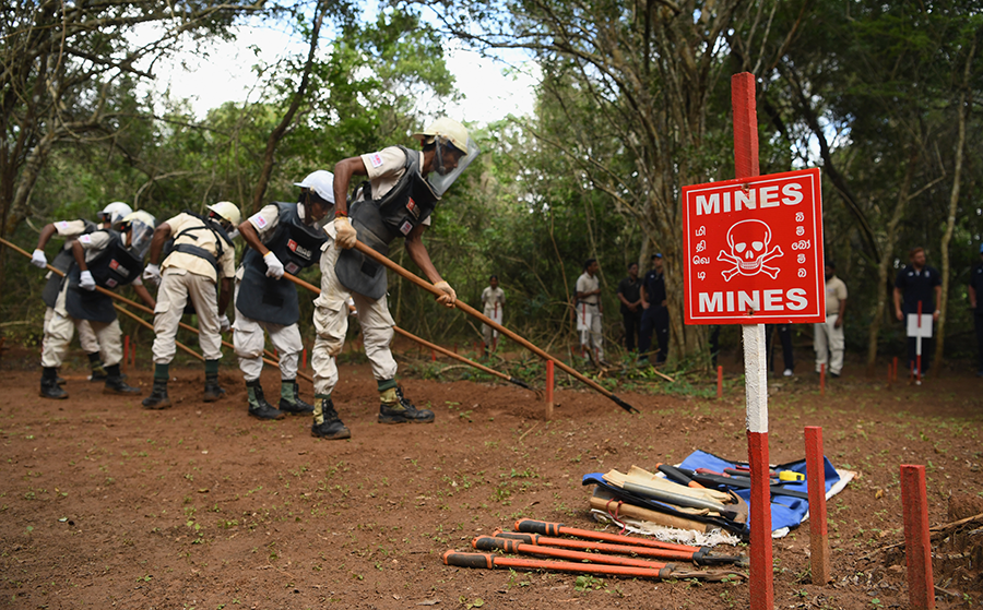 A Sri Lankan mine clearance crew demonstrates its techniques in 2018. About half of the states-parties with landmines deployed at one time on their territory have successfully completed their removal. (Photo: Stu Forster/Getty Images)