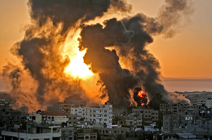 A fire rages at sunrise in Khan Yunish following an Israeli airstrike on targets in the southern Gaza strip, on May 12, 2021. The Israeli retaliatory bombardment in May struck military and civilian targets. (Photo:  Youssef Massoud/AFP via Getty Images)