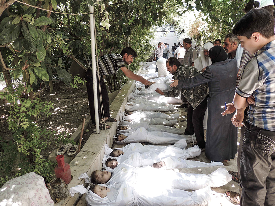 A mother and father weep over the body of their child, who was killed in a chemical weapons attack on the Damascus suburb of Ghouta, in August 2013. The OPCW says there have been 17 cases of chemical attacks in Syria, including Khan Shaykhun and Ltamenah, both in 2017. (Photo by NurPhoto/Corbis via Getty Images)