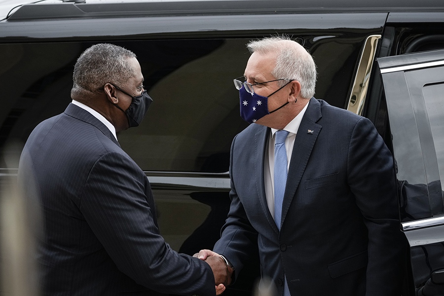 U.S. Defense Secretary Lloyd Austin shakes hands with Australian Prime Minister Scott Morrison as the latter arrives at the Pentagon on September 22. The meeting took place a week after the two countries and the United Kingdom announced the  AUKUS security pact to help Australia develop and deploy nuclear-powered submarines and pursue other military cooperation.  (Photo by Drew Angerer/Getty Images) 