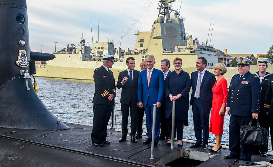 Australian Prime Minister Malcolm Turnbull (fourth from left), French President Emmanuel Macron (second left) and other officials visit the Australian submarine HMAS Waller in Sydney in May 2018 when France was still planning to sell submarines to Australia. That deal has now been upended by the AUKUS arrangement. (Photo by Brendan Esposito - Pool/Getty Images)