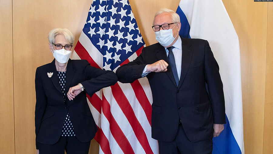 U.S. Deputy Secretary of State Wendy Sherman (left) and Russian Deputy Foreign Minister Sergei Ryabkov, leaders of their respective delegations, bump elbows  in front of their national flags before a round of strategic stability talks in Geneva on July 28. (Photo by U.S. Mission Geneva)