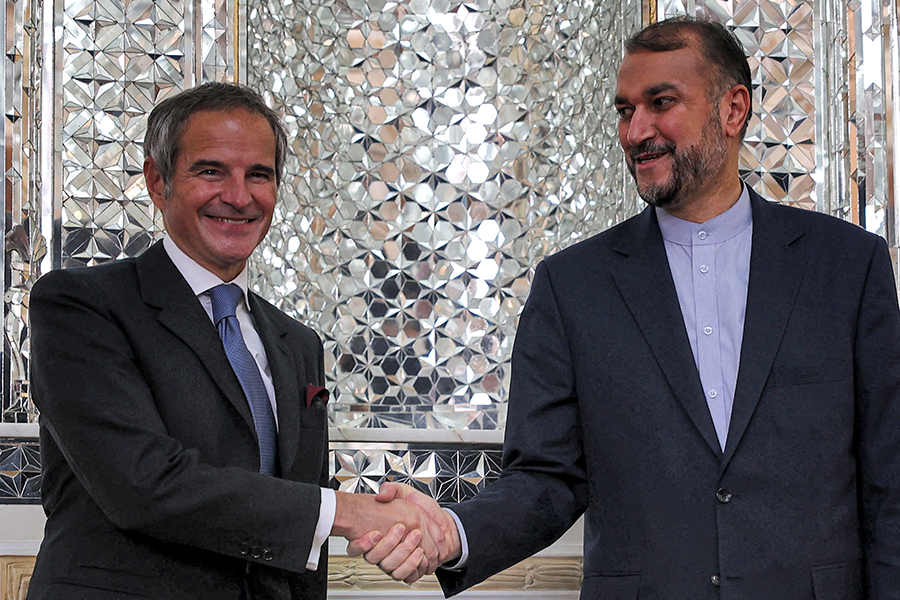 Iran's Foreign Minister Hossein Amirabdollahian shakes hands with the Director-General of the International Atomic Energy Agency (IAEA) Rafael Mariano Grossi at the foreign ministry headquarters in the capital Tehran on November 23, 2021.  (Photo by ATTA KENARE/AFP via Getty Images)