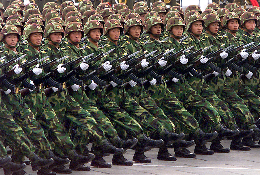 Some experts believe that the Chinese nuclear buildup is driven, at least in part, by Beijing's determination to achieve national unification with Taiwan. Chinese People's Liberation Army soldiers, pictured here, march during a parade in 1999. (Photo by Stephen Shaver/AFP via Getty Images)