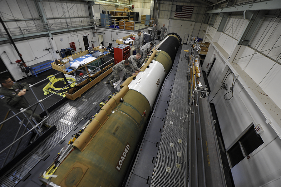 An aging Minuteman III missile, slated to be replaced by the new Ground-Based Strategic Deterrent system, is fitted with a new cable by members of the U.S. Air Force. (Photo by U.S. Air Force)