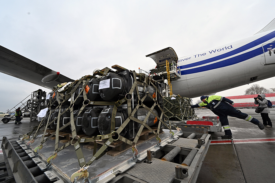 Employees at the airport in Kyiv on Feb. 11 unload a Boeing 747-412 plane with the FGM-148 Javelin, a man-portable anti-tank missile provided by the United States as part of its military support to Ukraine ahead of the Russian invasion.  (Photo by Sergei Supinsky/AFP via Getty Images)