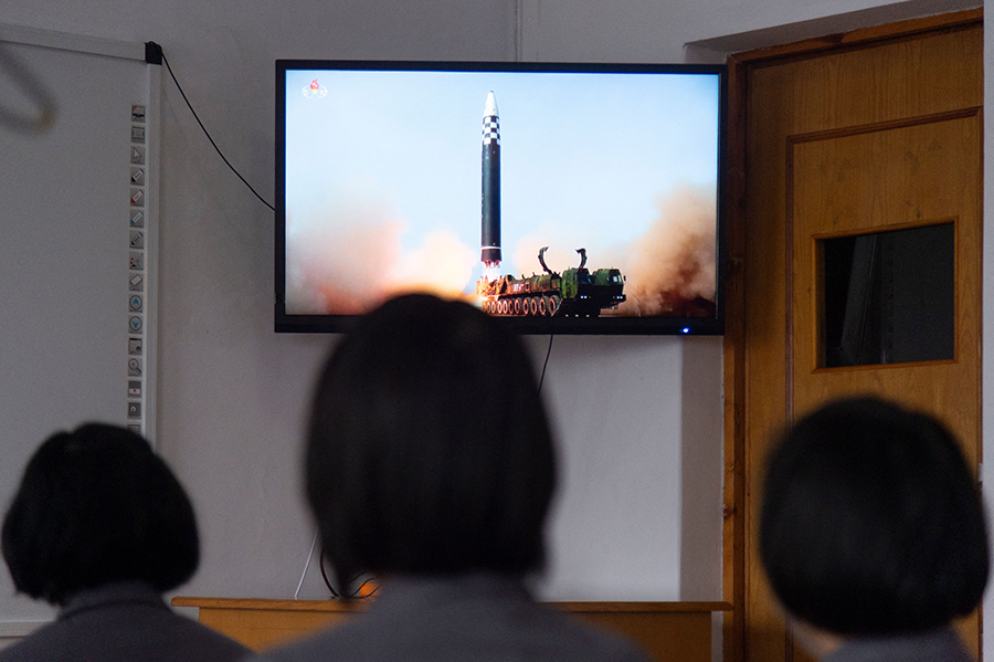 In this photo taken in Pyongyang on March 25, students of the Pyongyang Jang Chol Gu University of Commerce watch footage of the previous day's launch of a North Korea missile. (Photo by Kim Won Jin/AFP via Getty Images)