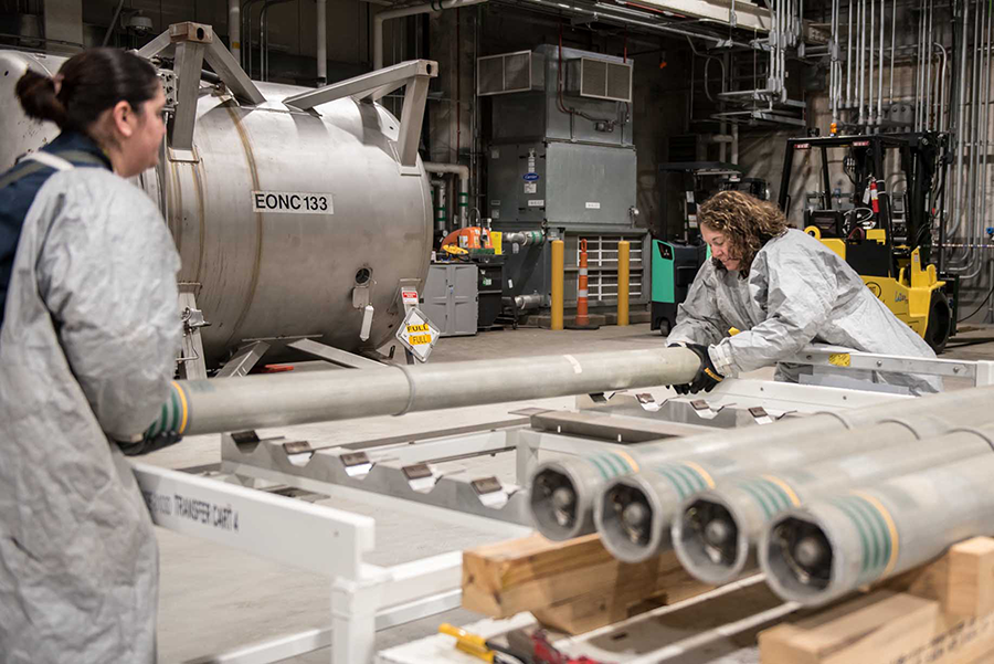 Operators move rockets containing VX nerve agent from a pallet to a transfer cart to begin the destruction process at the Blue Grass Chemical Agent-Destruction Pilot Plant in Kentucky. The rockets were among the last with VX in the U.S. stockpile to be destroyed. The U.S. Defense Department is now trying to speed up the destruction of chemical weapons at a site in Pueblo, Colorado.  (Photo courtesy of Bechtel)