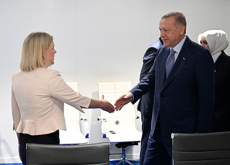 Swedish Prime Minister Magdalena Andersson (L) shakes hands with Turkish President Recep Tayyip Erdoğan during a meeting on the sidelines of the NATO summit in Madrid on June 28. The talks, which also included Finnish President Sauli Niinistö, appeared to resolve Turkey's objections over Finland and Sweden joining NATO. (Photo by Henrik Montgomery/TT News Agency/AFP via Getty Images)