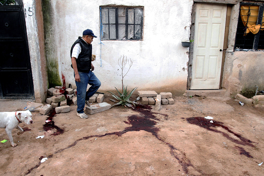 A man looks at the site where an armed group executed six people inside an addiction clinic in San Pedro Tlaquepaque, state of Jalisco, Mexico, on July 25. (Photo by Ulises Ruiz/AFP via Getty Images)