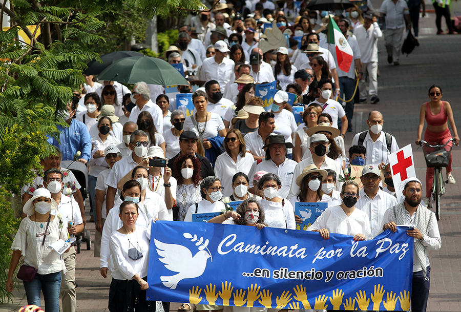 People take part in a ‘Walk for Peace’ to ask for a stop to violence, extortions, executions, and disappearances of people in Mexico, in Guadalajara, Mexico, on July 31. (Photo by Ulises Ruiz/AFP via Getty Images)