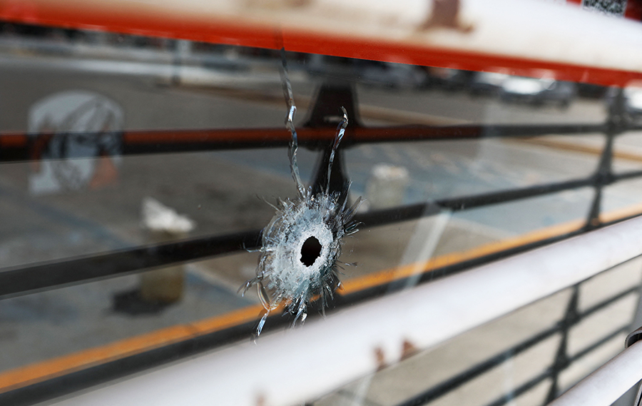A bullet hole is seen on the door of a restaurant close to the site where four radio station workers were killed in Ciudad Juarez, state of Chihuahua, Mexico, on August 12. (Photo by Herika Martinez/AFP via Getty Images)