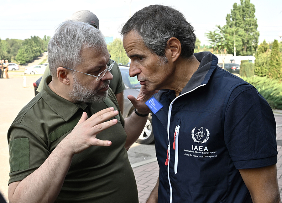 Rafael Mariano Grossi (R), director-general of the International Atomic Energy Agency (IAEA), speaks with Ukrainian Minister of Energy German Galushenko on arrival of the IAEA inspection mission to Zaporizhzhia nuclear power plant in Ukraine on Aug. 31.  (Photo by Genya Savilov/AFP via Getty Images)