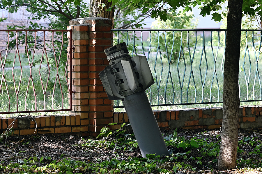 A tail section of a 300mm rocket which appears to have contained cluster bombs launched from a BM-30 Smerch multiple rocket launcher is seen embedded in the ground on July 3 after shelling in Kramatorsk, amid the Russian war on Ukraine.  (Photo by Genya Savilov / AFP via Getty Images)