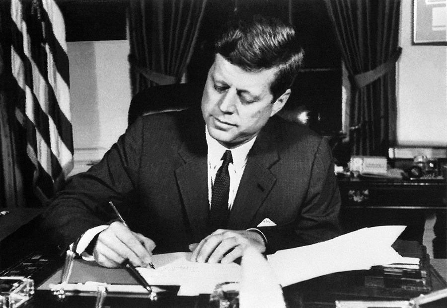 U.S. President John Kennedy signs the order for a naval blockade of Cuba on October 23, 1962 at the White House during the Cuban missile crisis. (Photo by -/AFP via Getty Images)