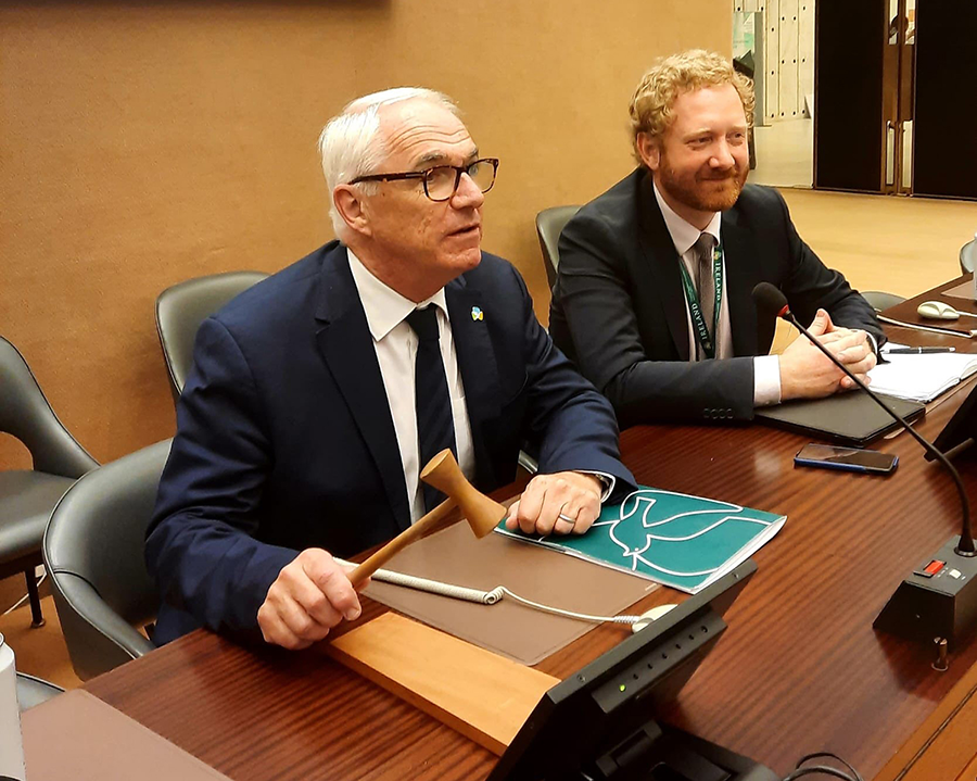 Michael Gaffey (L), Irish ambassador to the United Nations in Geneva who headed negotiations on the political declaration on the use of explosive weapons in populated areas, and Jamie Walsh, Irish deputy permanent representative in Geneva in charge of disarmament issues, bring down the gavel after the declaration was agreed in June.  (Photo courtesy of the Permanent Mission of Ireland to the United Nations in Geneva)