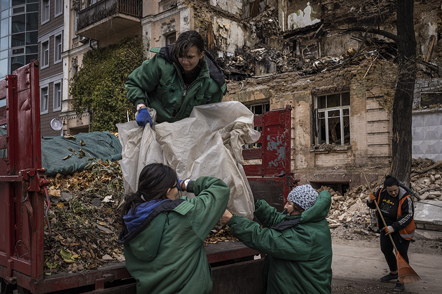 Drones supplied to Russia by Iran are wreaking havoc on civilians in Ukrainian cities like Kyiv where in October, people cleared blast debris and leaves outside a house where a couple was killed by a Russian drone strike. (Photo by Ed Ram/Getty Images)