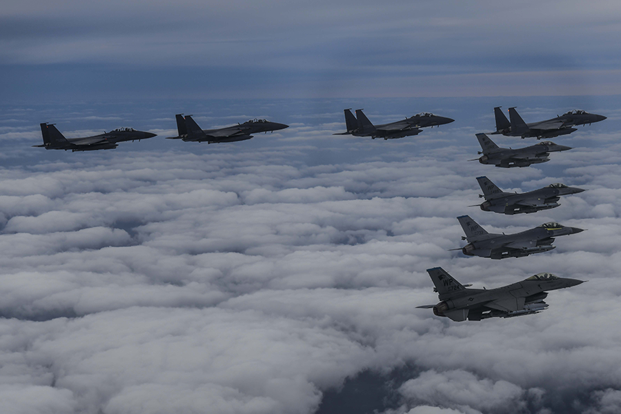 In this image released by the South Korean Defense Ministry, South Korean Air Force F-15Ks and U.S. Air Force F-16 fighter jets fly over the Korean Peninsula in response to North Korea's intermediate-range ballistic missile launch earlier on Oct. 4.  (Photo by South Korean Defense Ministry via Getty Images)