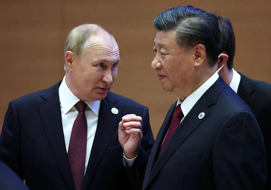 Russian President Vladimir Putin (L) and Chinese President Xi Jinping confer during the Shanghai Cooperation Organization summit in Samarkand in September. The Biden administration national security strategy says the United States must modernize its nuclear triad to deter the nuclear rivals that these leaders represent.  (Photo by Sergei Bobylyov/SPUTNIK/AFP via Getty Images)