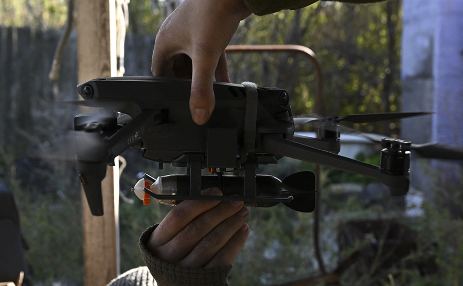 A Ukrainian soldier loads a bomb on a drone in Bakhmut, Donetsk region, in September amid the Russian war on Ukraine.  (Photo by JUAN BARRETO/AFP via Getty Images)