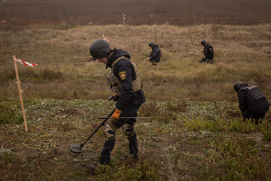 A Ukrainian team worked to clear mines and unexploded ordinance from the side of the main road leading to Kherson City, Ukraine, in November. Kherson was the only regional capital to be captured by Russia following its invasion on Feb. 24.  (Photo by Chris McGrath/Getty Images)