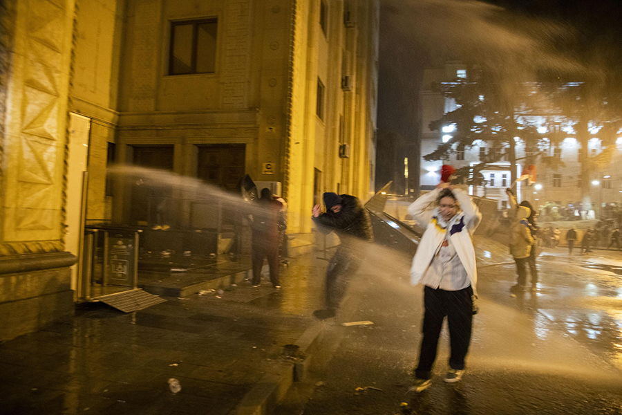 Police in Tbilisi, Georgia, used water cannons, pepper spray and tear gas against thousands of people who gathered outside the Georgian parliament on March 8 to protest a controversial draft law that would require some organizations receiving foreign funding to register as “foreign agents.” Activists decry the law as a breach of human rights. (Photo by Daro Sulakauri/Getty Images)