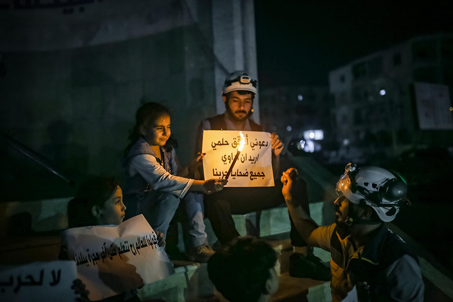 Last August, people in Idlib, Syria, staged a demonstration against the Assad regime for its chemical weapons attack on Eastern Ghouta in 2013. Thousands of women and children were affected by the poisonous agents used in the attack.  (Photo by Muhammed Said/Anadolu Agency via Getty Images)