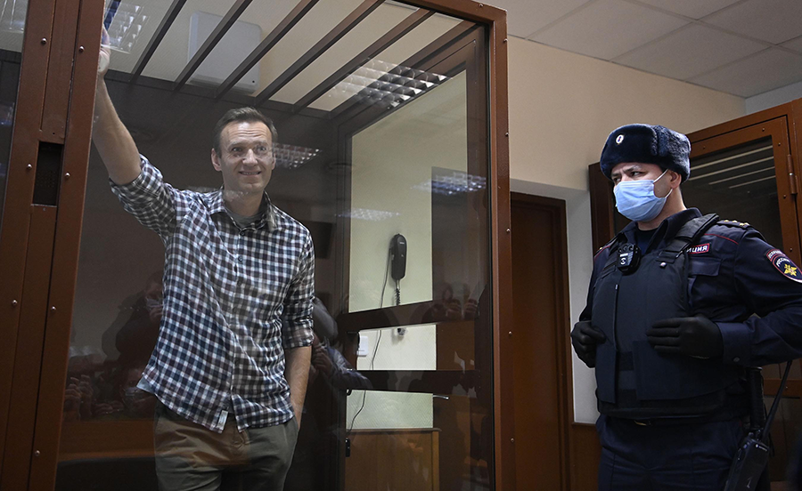 Russia is blamed for the near fatal poisoning of the now-imprisoned opposition leader Alexei Navalny, seen inside a glass cell during a district court hearing in Moscow in 2021. Russia and Syria are the only two states-parties to the Chemical Weapons Convention that are accused of using chemical weapons. (Photo by Kirill Kudryavtsev/AFP via Getty Images)