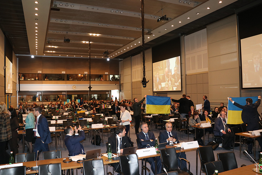 During the February meeting of the Organization for Security and Cooperation in Europe (OSCE) Parliamentary Assembly in Vienna, the Russians faced walkouts and ridicule from other delegates, some of whom showed support for Ukraine by holding up Ukrainian flags. (Photo by OSCE)