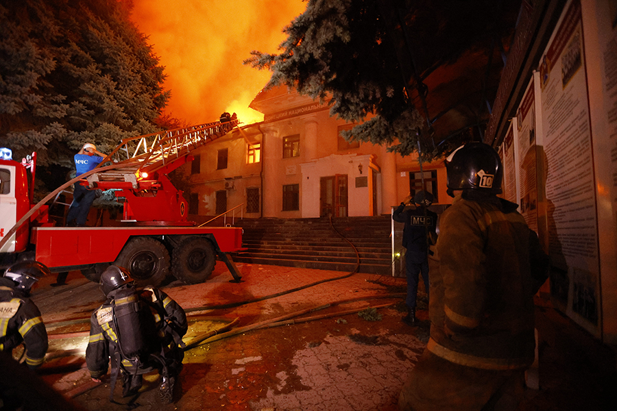 Firemen try to put out fire at Donetsk University of Economics and Trade in Russian-occupied Donetsk, Ukraine, on Aug. 5. The city’s mayor told reporters that Ukrainian forces used cluster munitions to attack the building. The United States recently provided Ukraine with cluster munitions, which are banned by more than 100 countries. (Photo by Victor/Xinhua via Getty Images)