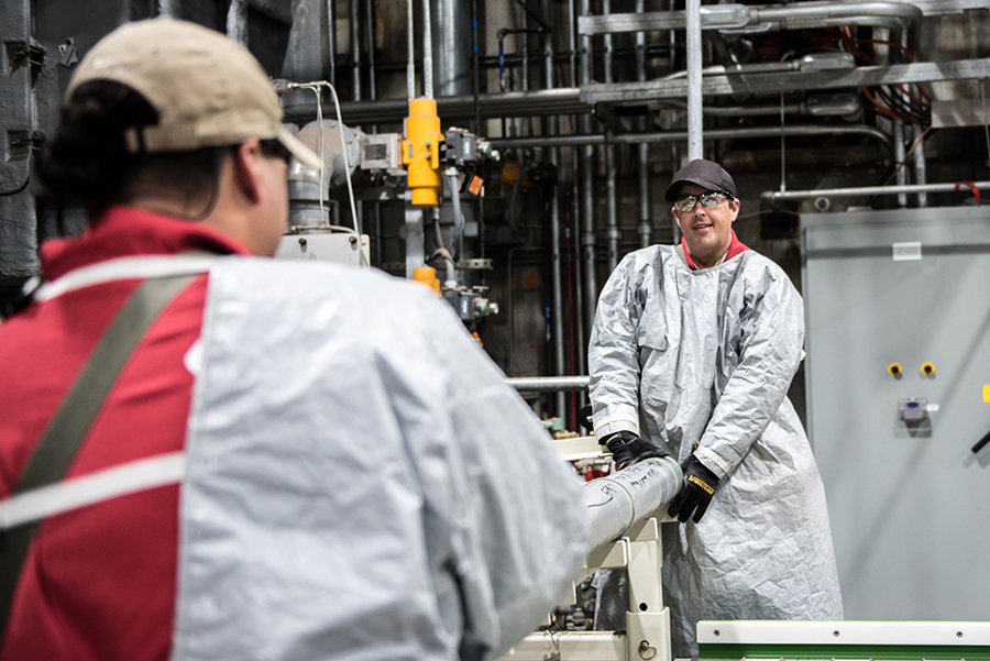 Operators place the last M55 rocket containing GB nerve agent on a conveyor to begin the destruction process at the Blue Grass Chemical Agent-Destruction Pilot Plant on July 7. This was the last munition destroyed in the declared U.S. chemical weapons stockpile. (Photo by U.S. Army)