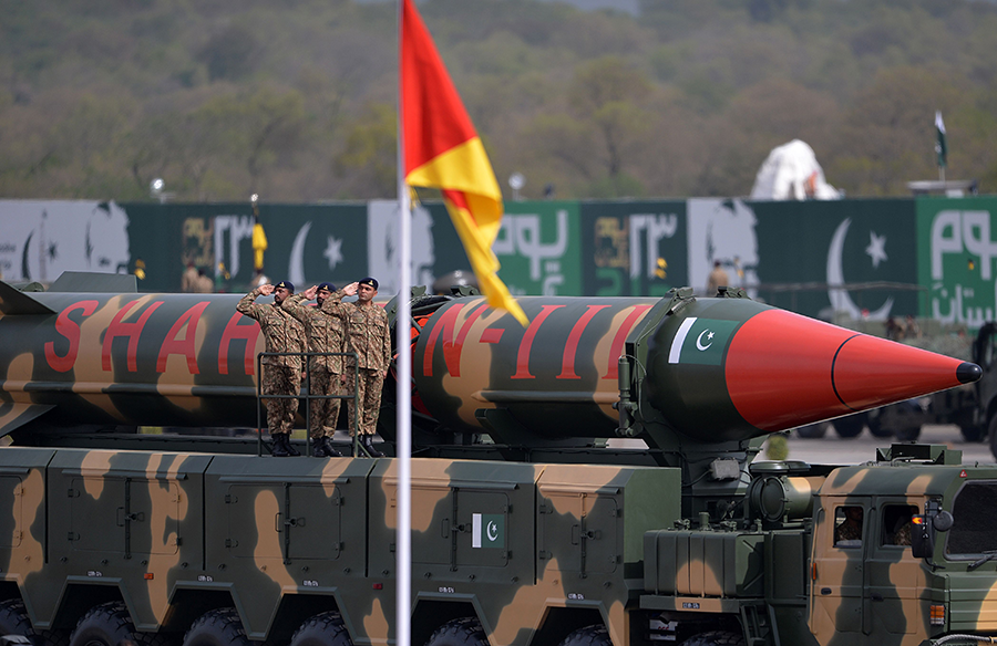 Pakistani army soldiers salute as they accompany a Shaheen III long-range ballistic missile during the Pakistan Day military parade in Islamabad in March 2016.  (Photo by Aamir Qureshi/AFP via Getty Images)