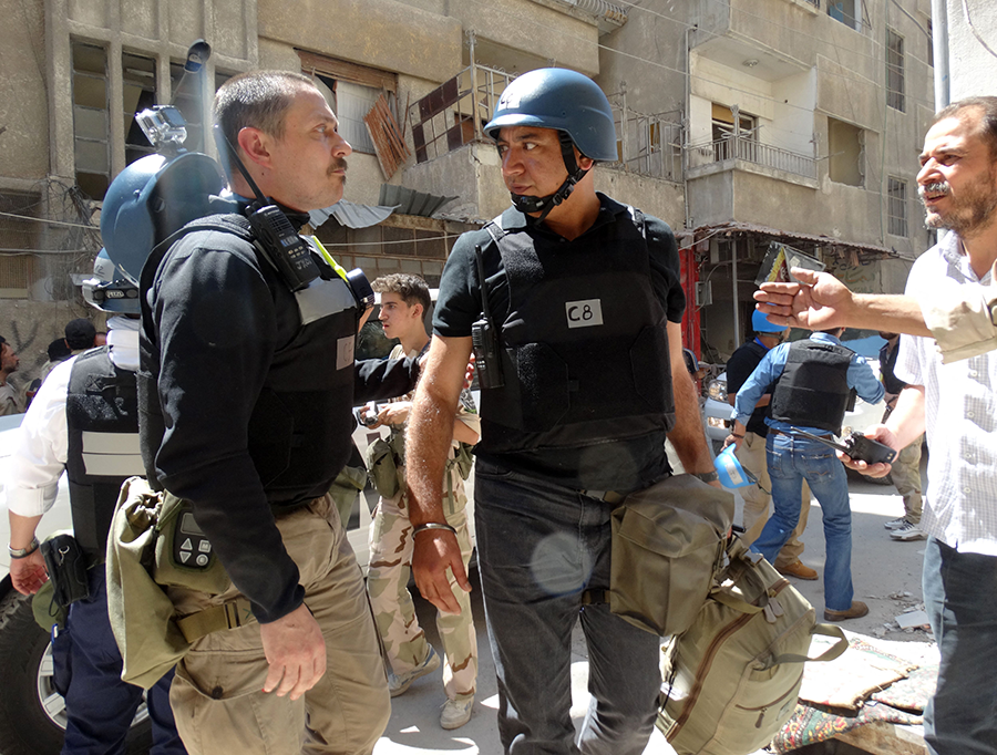 UN arms experts arrive to inspect a site suspected of being hit by a deadly chemical weapons attack on August 28, 2013 in the Ghouta area near Damascus. (Photo by Mohamed Abdulla/AFP via Getty Images)