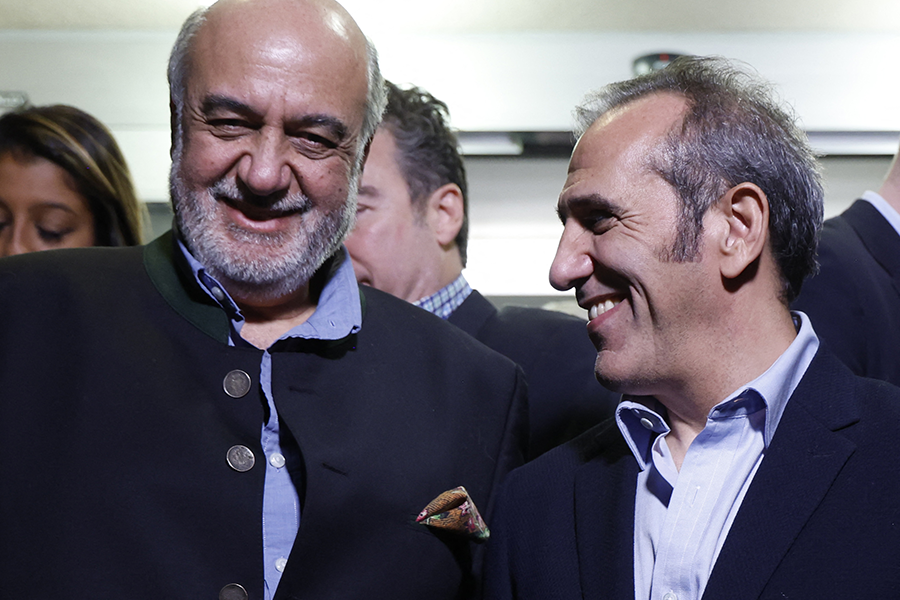 Morad Tahbaz (L) and Emad Shargi arrive at Davison Army Airfield at Fort Belvoir, Virginia on Sept. 19, one day after they and three other Americans imprisoned by Iran were released in a deal with the United States that gives Tehran access to $6 billion in frozen funds. (Photo by Jonathan Ernst/POOL/AFP via Getty Images)