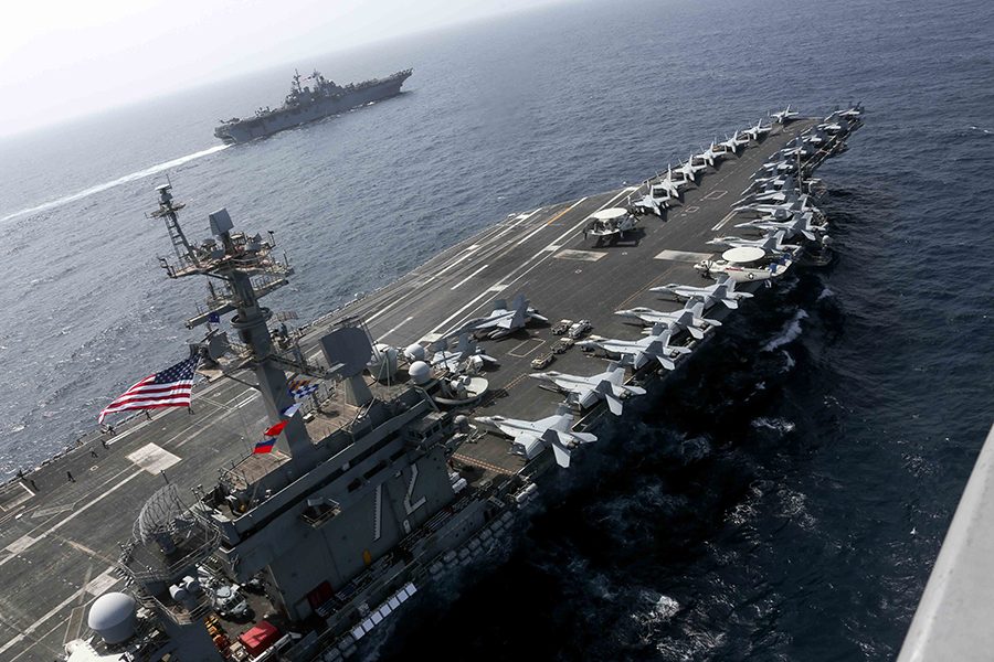 The Nimitz-class aircraft carrier USS Abraham Lincoln (CVN 72) and the Wasp-class Amphibious Assault Ship USS Kearsarge (LHD 3), showcasing an array of powerful U.S. military assets, sail during exercises in the Arabian Sea in 2019. A bipartisan congressional commission wants the United States to respond to two near-peer rivals, China and Russia, by building up more nuclear forces.  (Photo by Petty Officer 1st Class Brian Wilbur)