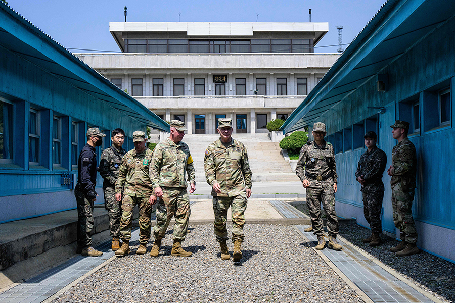 U.S. Army Chief of Staff General James McConville (C, front) at the military demarcation line separating North Korea and South Korea in the Demilitarized Zone (DMZ) in May. Top defense officials from 18 countries that are part of the UN Command monitoring the DMZ recently pledged to respond jointly to any attack that threatens South Korean security.  (Photo by Anthony Wallace/AFP via Getty Images)