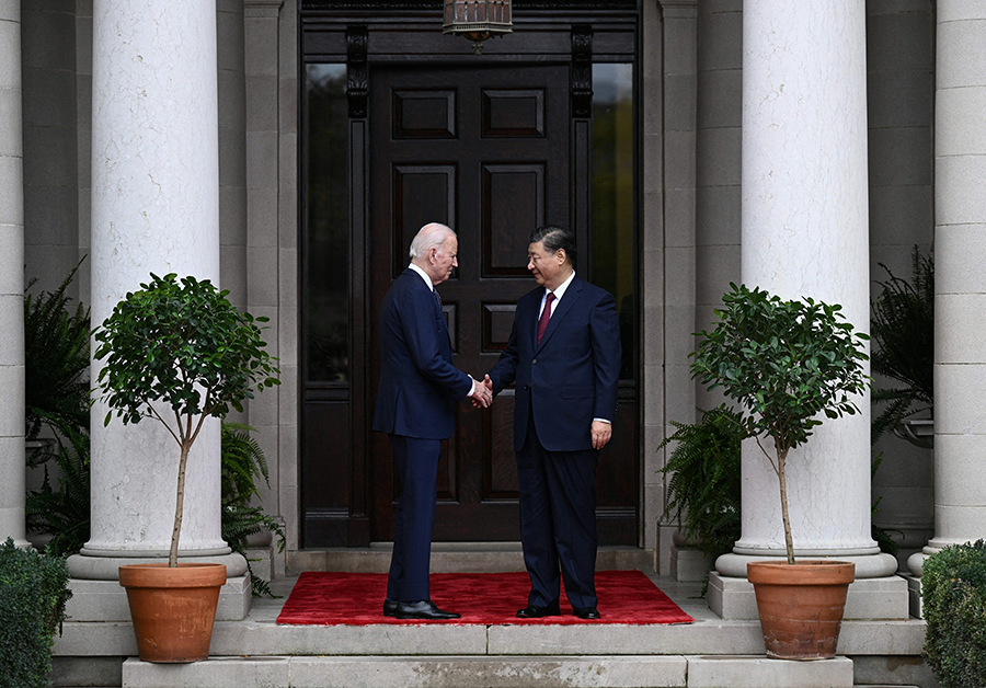 U.S. President Joe Biden (L) greets Chinese President Xi Jinping at the start of their bilateral summit Nov. 15 on the sidelines of the  Asia-Pacific Economic Cooperation leaders meeting near San Francisco. It was the first Biden-Xi encounter in a year and marked an effort to ease growing tensions between the two countries. (Photo by Brendan Smialowski/AFP via Getty Images)