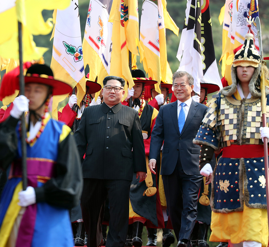 In April 2018, South Korean President Moon Jae-in (R) and North Korean leader Kim Jong Un (L) were all smiles during the welcoming ceremony that was part of their meeting on the South Korean side of the demilitarized zone. Since then, Kim has designated the South as the North’s principal enemy.  (Photo by Inter-Korean Summit Press Corps / Pool/Anadolu Agency/Getty Images)