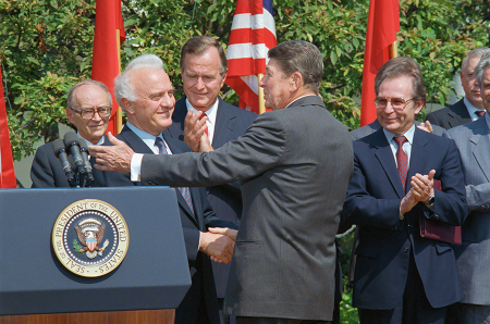 Disarmament agreements generally have occurred during periods of relative normalization between Russia, or its predecessor the Soviet Union, and the United States. In September 1987, U.S. President Ronald Reagan (R, back to camera) spoke with Soviet Foreign Minister Eduard Shevardnadze at the White House while U.S. Vice President George H.W. Bush looks on. Afterward, Shevardnadze and U.S. Secretary of State George Shultz signed an agreement limiting the chances of accidental nuclear war.  (Photo by Bettmann Archives via Getty Images)