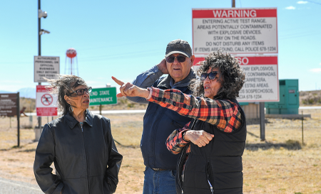 Louisa Lopez (L), Wesley Burris and Tina Cordova at White Sands Missile Range in New Mexico, where the first nuclear test, called “Trinity,” took place. Thousands of people who have lived within range of the test site potentially could qualify for a U.S. aid program for victims that is due to expire June 7. (Photo by Valerie Macon/AFP via Getty Images)