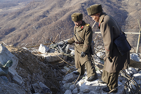 South Korean and North Korean army soldiers inspect a dismantled North Korean guard post inside the Demilitarized Zone in the inter-Korean border in Cheorwon, North Korea in December 2018. The demolition was mandated by the Comprehensive Military Agreement to reduce military tensions and build trust.  (Photo by Seung-il Ryu/NurPhoto via Getty Images)