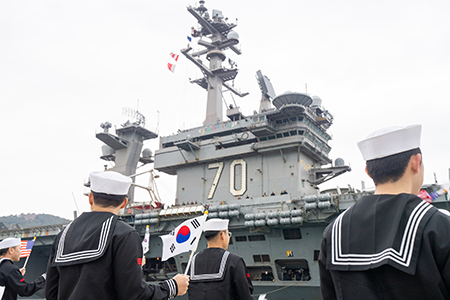 South Korean sailors welcome the Nimitz-class aircraft carrier USS Carl Vinson as the ship pulls into Busan, South Korea, for a port visit March 2. (U.S. Navy photo by Mass Communication Specialist Seaman Robert A. Moses)