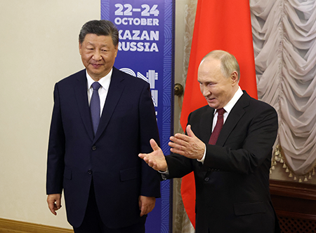 Russian President Vladimir Putin (R) greets Chinese President Xi Jinping during their bilateral meeting on the sidelines of the BRICS Leader's Summit in October in Kazan, Russia. Expert Toby Dalton writes that U.S. President Donald Trump’s shift toward Russia may be a great-power gambit to woo Russia to the U.S. side against China. (Photo by Contributor/Getty Images)