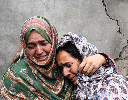 Women grieve after their home was destroyed May 8 following cross-border shelling between Pakistani and Indian forces near the Line of Control in disputed Kashmir.  (Photo by Basit Zargar/Middle east images/AFP via Getty Images)
