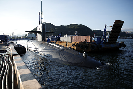 Adversary integration of AI-enhanced systems that can reliably locate submerged ballistic missile submarines could erode confidence in a state’s assured retaliation posture, writes Lt. Gen. John N.T. Shanahan. Here, the U.S. ballistic missile submarine USS Kentucky is anchored at Busan Naval Base in South Korea in 2023.  (Photo by Woohae Cho/POOL/AFP via Getty Images)
