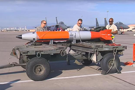 As part of a plan to bolster its nuclear deterrent, the United Kingdom appears to have reintroduced a U.S. gravity nuclear bomb, the B61-12, back onto its territory. In this photo, U.S. Air Force technicians prepare a flight test the weapon at the Nevada Test and Training Range. (Screengrab of U.S. Air Force Video by SSgt. Cody Griffith)