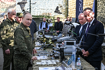 Russian President Vladimir Putin (L, Front) tours an exhibition of military equipment while inspecting the “Zapad-2025” joint Russian-Belarusian military drills at a training ground in the Nizhny Novgorod Oblast on Sept. 16. (Photo by Sergei Bobylyov/POOL/AFP via Getty Images)